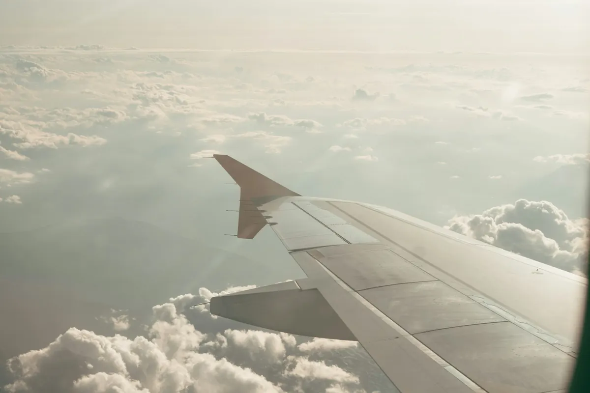 Aircraft wing above a layer of cloud