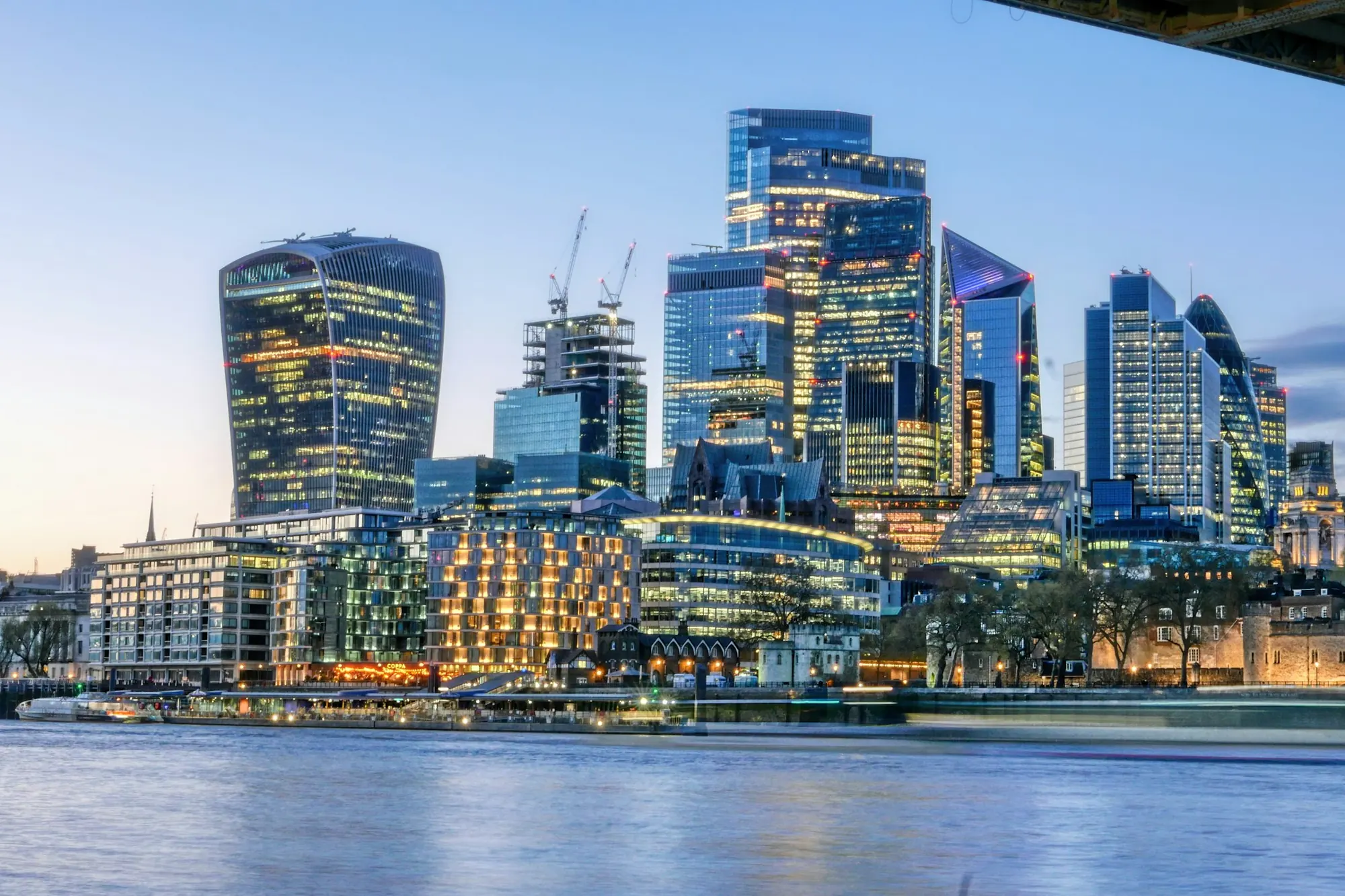 The City of London skyline across the Thames at dusk